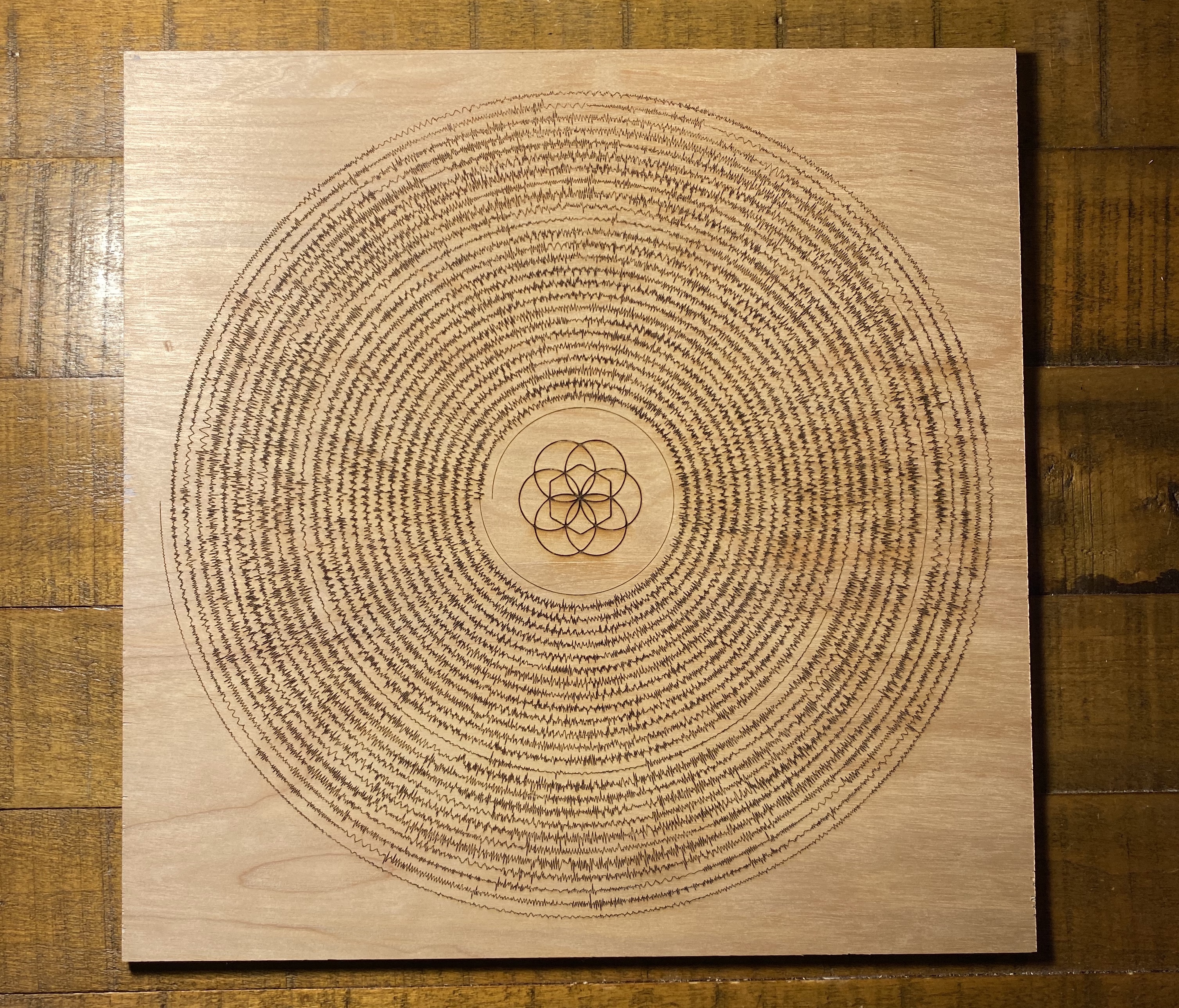 An example of a curved spiral design with a center icon etched separately